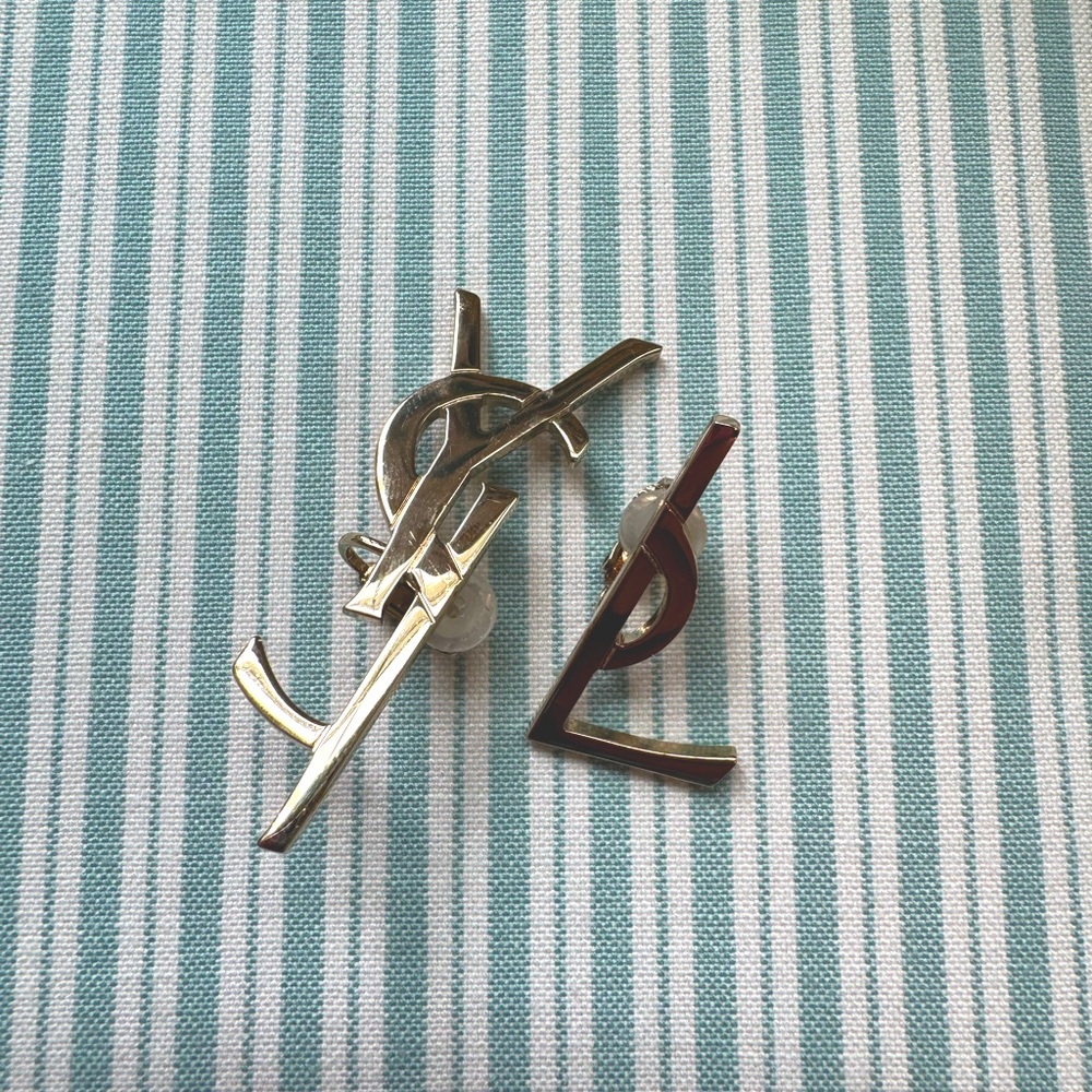 YSL clip on gold colored earrings. YS for one ear and L for the other.